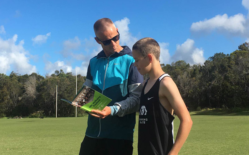 Image of program facilitator with young boy with the Wellbeing Playbook