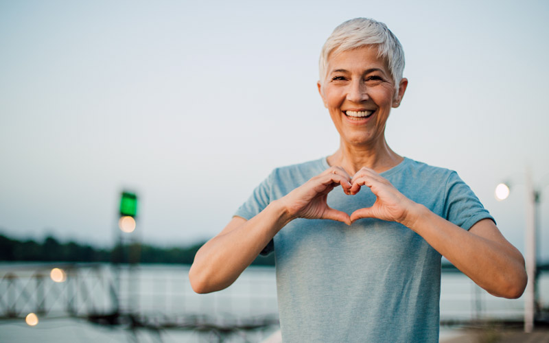 Image of positive woman hands in shape of heart employee wellbeing